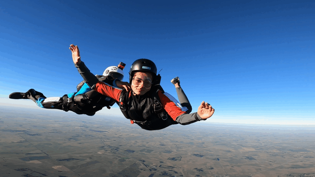 Alumno de curso AFF saltando asistido por instructor